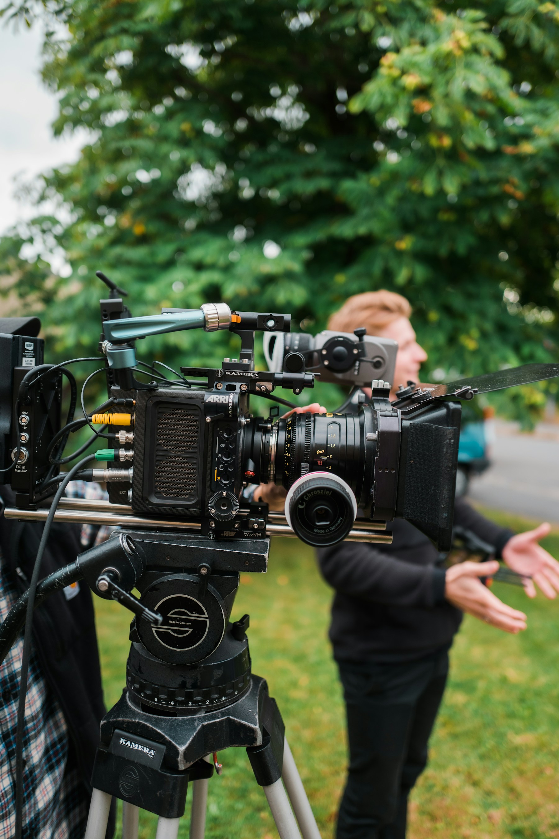 A professional cinema camera and operator outdoors